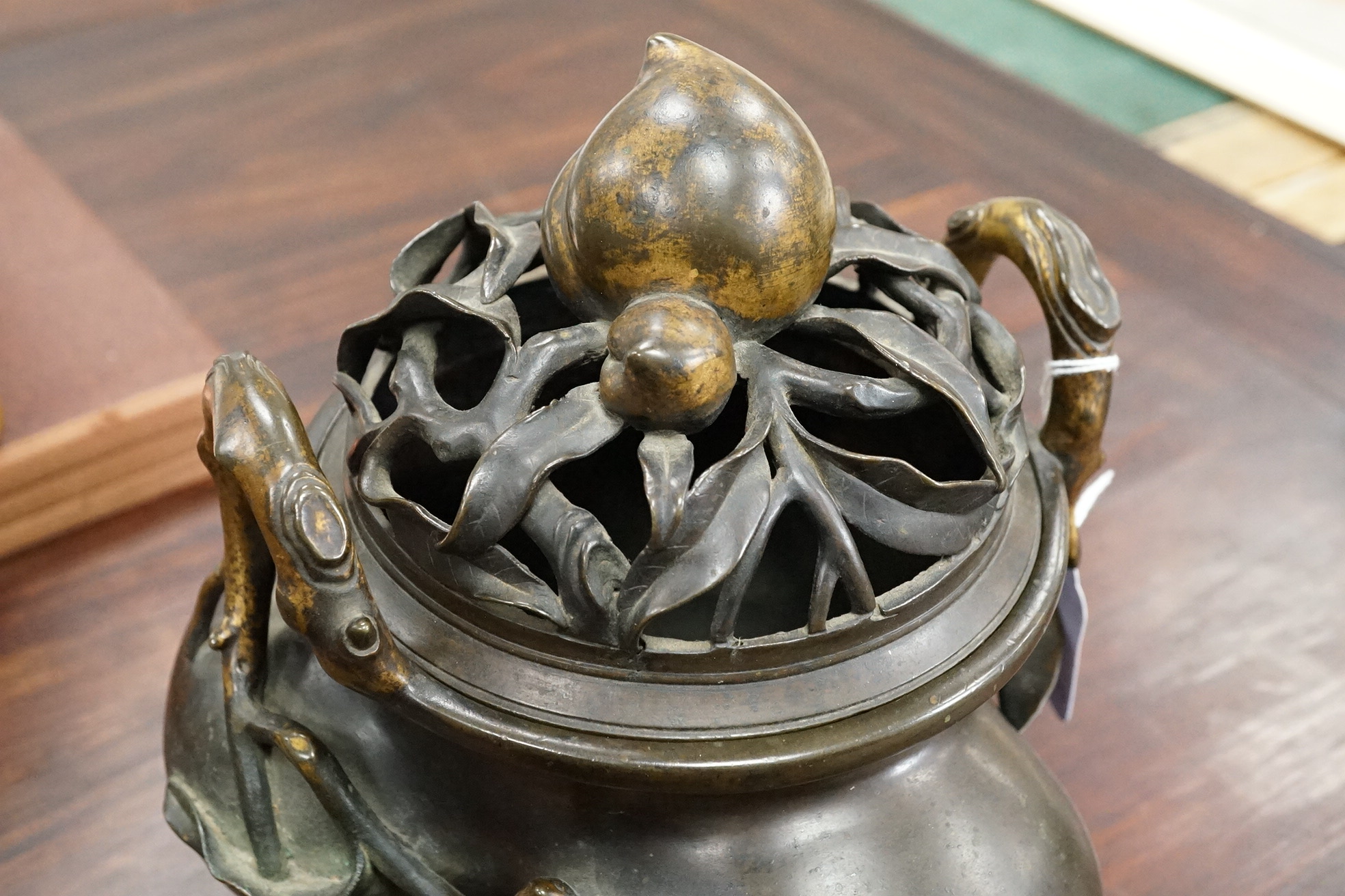 A large Chinese bronze and parcel gilt ‘peach’ censer and cover, Li, 17th/18th century